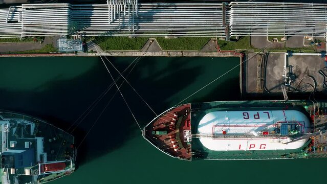 Aerial top down view ship LPG tankers vessel loading in gas and oil terminal station refinery, Global trading import export logistic transport sea freight Liquefied Petroleum Gas tanker