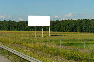 A large billboard stands prominently on the side of a busy road