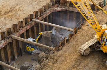 Busy Construction Site With Yellow Crane