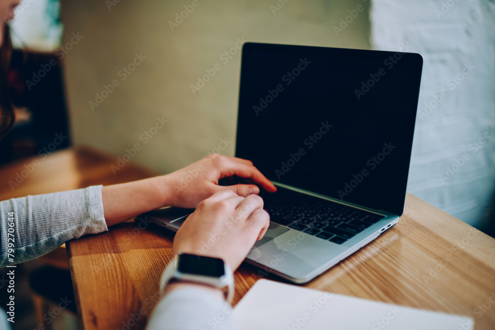Poster cropped image of female freelancer using laptop computer for searching information and browsing webs