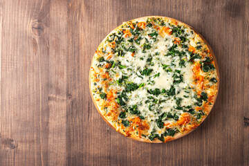 Vegetarian pizza with spinach, arugula, pesto, cheese and parmesan. Italian cuisine. 