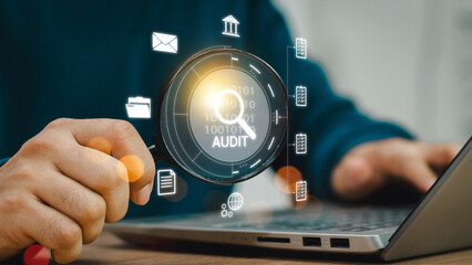 Audit business concept. Businessmen use laptops to check and evaluate financial statements. ...