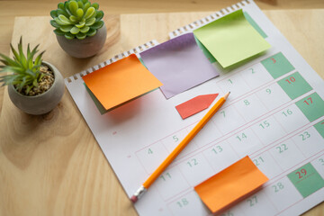 A Calendar On A Desk With Colorful Sticky Notes And A Pencil. Concept About The Organization And...