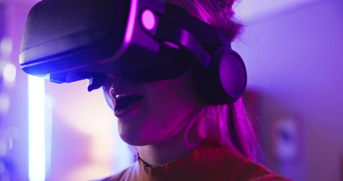 Gaming, virtual reality goggles and woman with controller at night for entertainment, online games and esports. Gamer, neon light and person with vr glasses for metaverse, cyber world and competition