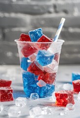 red white and blue ice cubes in a clear plastic cup - obrazy, fototapety, plakaty