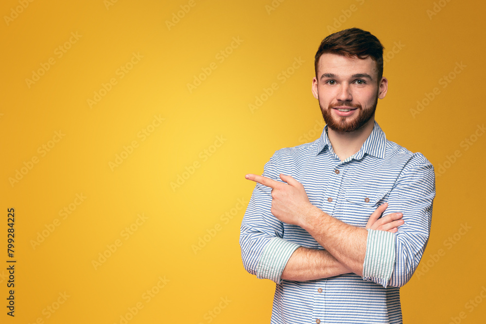 Wall mural man crossing arms against yellow background