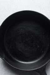 Overhead view of seasoned cast iron skillet, flatlay of cast iron frying pan