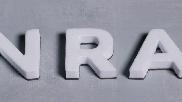 NRA National Rifle Association 3d letters close up concept light blue background