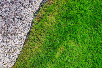 Gravel and lawn in home garden. Gardening concept background. Lawn edge close up summer