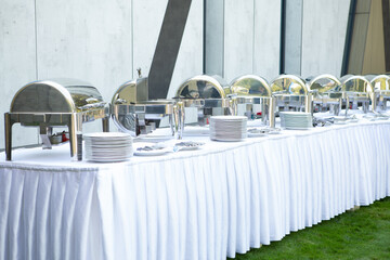 Catering table with food warmers and utensils