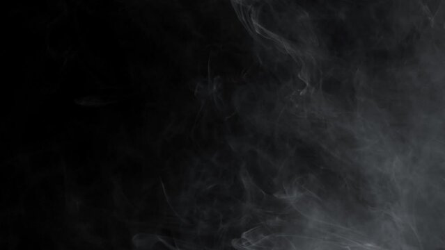 Abstract white smoke in slow motion. Smoke, Cloud of cold fog in light spot background. Light, white, fog, cloud, black background, 4k, ice smoke cloud. Floating fog.	
