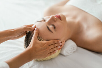 Woman Receiving Facial Massage at Spa, View Above