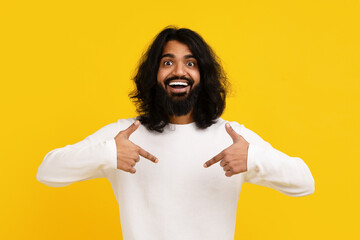 Cheerful Man With Long Hair Pointing at Himself