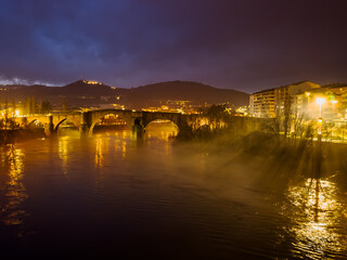 Misty River Nightscape: The Glow of the Old Bridge