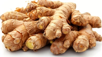 Pile of ginger roots on white surface