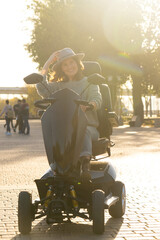 Woman tourist riding a four wheel mobility electric scooter on a city street