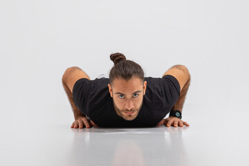 Man Performing Push Up Exercise On Grey Background - obrazy, fototapety, plakaty