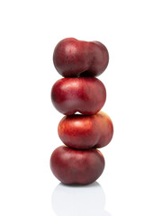 four peaches stacked nectarines plum fruit isolated on white background. clipping path included.