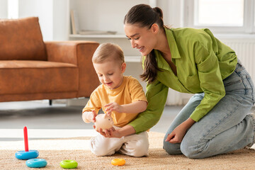 Woman Young Mother Playing With Child on the Floor