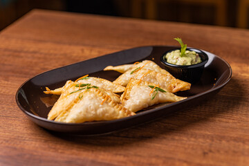 Tequeños stuffed with lomo saltado with guacamole sauce