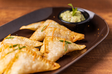 Tequeños stuffed with lomo saltado with guacamole sauce