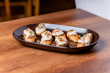 Open your mouth, garlic bread with acevichada sauce in the foreground.