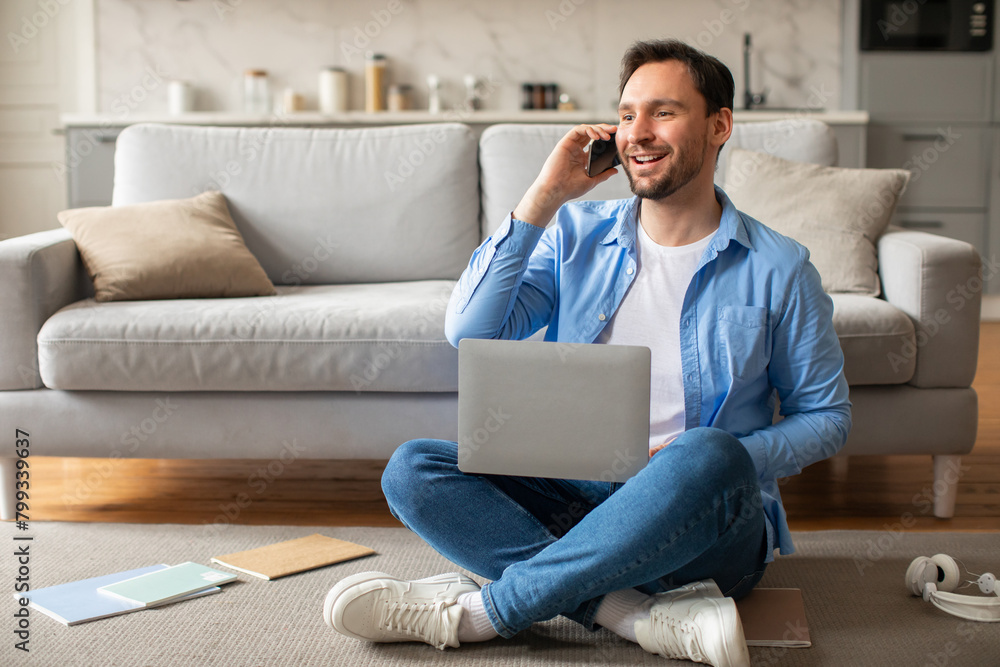 Aufkleber man sitting on floor using laptop while talking on phone