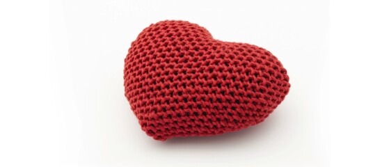Knitted red thread in the shape of a love on a white background