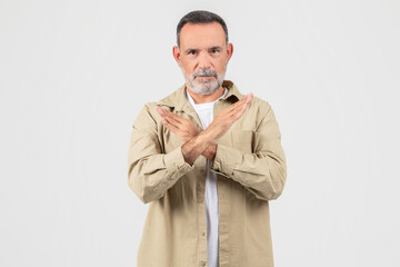 Man Standing With Hands Folded in Front of Chest