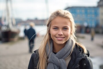 Young woman smiling outdoors in a city during winter