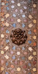 The image is of a wooden panel with a pattern of stars and circles