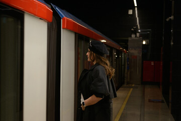 Beautiful lonely girl in black posing in the subway.