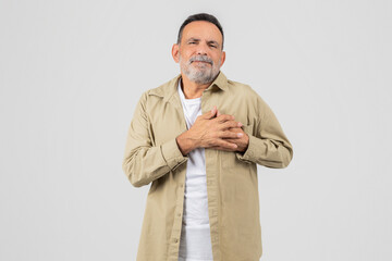 Man Standing With Folded Hands in Front of Chest