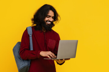Man Student With Long Hair and Beard Using Laptop