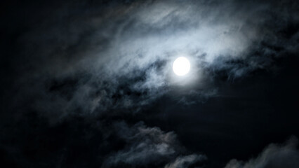 Dramatic night sky with moon and mystic clouds, scary dark gothic background. Concept of horror,...