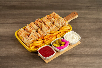 Arabic shawarma meal with french fries and appetizers

