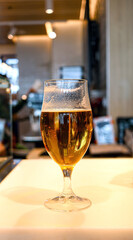 A pint of beer in a glass cup