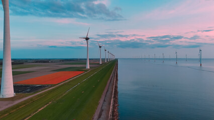 Aerial drone view wind turbine park ofsshore wind farm in the Netherlands on sunset