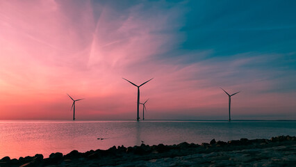 Aerial drone view wind turbine park ofsshore wind farm in the Netherlands on sunset