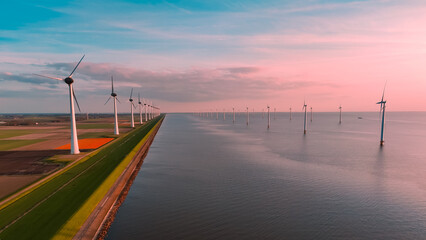 Aerial drone view wind turbine park ofsshore wind farm in the Netherlands on sunset