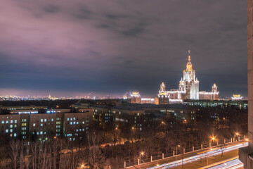 Twilight View of a Majestic University Building Illuminated in Moscow. The city lights begin to...
