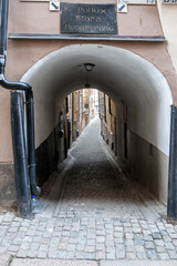 Stora Hoparegrand arched stonewall, covered cobblestone alley at Gamla Stan, Stockholm Sweden.
