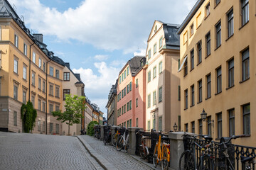 Traditional colorful building, paved street, parked bike in Stockholm, Gamla Stan Old Town, Sweden.