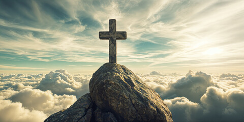 A large cross standing on top of a rock, set against a backdrop of clouds and a sunset.