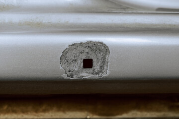 Part of a car body with a zinc protective coating applied, stripped of its paint coating. Car sill close-up. - 799367627