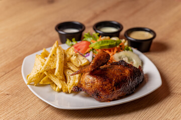 Peruvian grilled chicken, with fries and salad.