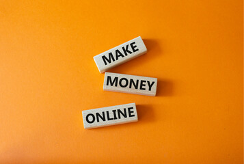 Make Money Online symbol. Concept words Make Money Online on wooden blocks. Beautiful orange background. Business and Make Money Online concept. Copy space.