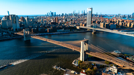 Bridge in the rays of setting sun. Scenic view of New York from aerial perspective.