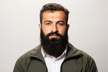Obraz premium Headshot of a man with a beard wearing a green jacket and white shirt