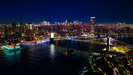 Lively traffic in never-sleeping New York at night. Scenic view of metropolis and waterscape of the...